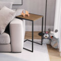 C-shaped Side Table over a sofa. Made of wood and black steel legs
