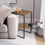 C-shaped Side Table over a sofa. Made of wood and black steel legs