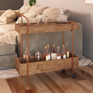 Industrial style bar cart made from wood and coppery steel legs with 2 shelves and 2 wheels